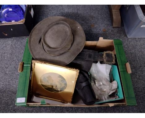 Box of assorted items to include: leather gun holster and ammo belt, two clear glass oil lamp chimneys, a framed print, leath