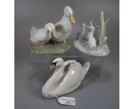 Royal Copenhagen 755 model of a swan together with a Royal Copenhagen 2128 model of two geese and another figure group of bir