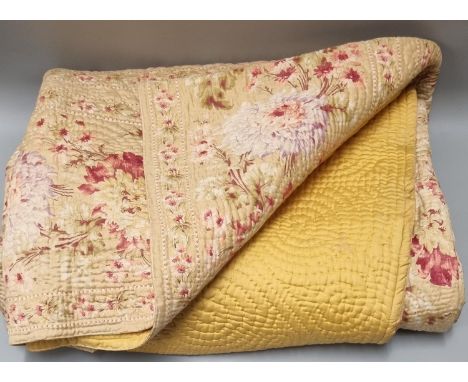 Vintage cotton double sided Welsh quilt with leaf and swirl pattern, one side plain mustard colour and the reverse floral pri