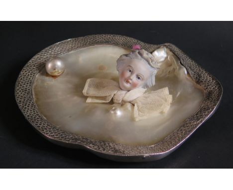 A Mother of Pearl Shell Dish mounted with a white metal border, pearl and ceramic head of a lady, c. 20cm wide 