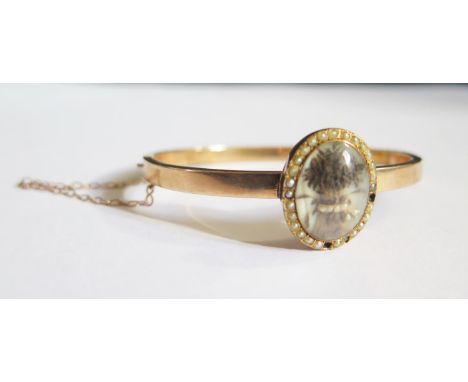 A Georgian Memorial 'Wheatsheaf' Hair and Seed Pearl Memorial Locket with seed pear surround and mounted on a precious yellow