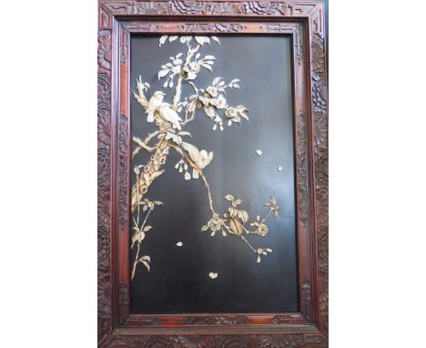 A Japanese Meiji Period Ivory Relief Picture of birds with inset mother of pearl eyes sitting on blossoming branches, 72.5x48