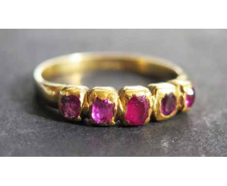 An 18ct Yellow Gold and Ruby Five Stone Ring, size T.5, 4.3g 