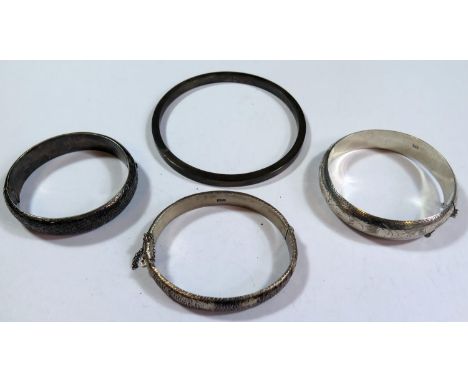 A Sterling Silver Bangle, two hinged bangles and white metal hinged bangle (43.3g sterling) 