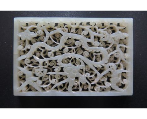 A Finely Carved and Pierced Chinese Jade Panel decorated with a dragon, bat and bird amongst scrolling foliate work carved on