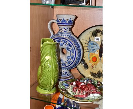 A STUDIO POTTERY CHARGER AND THREE OTHER PIECES OF POTTERY, comprising a circular terracotta charger painted with a butterfly