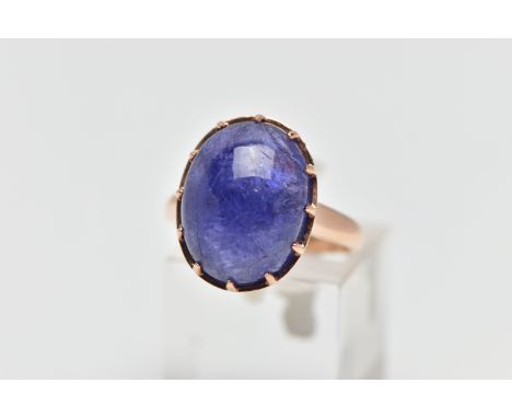 A TANZANITE CABOCHON RING, comprising an oval tanzanite cabochon within a claw setting to the tapered band, approximate dimen