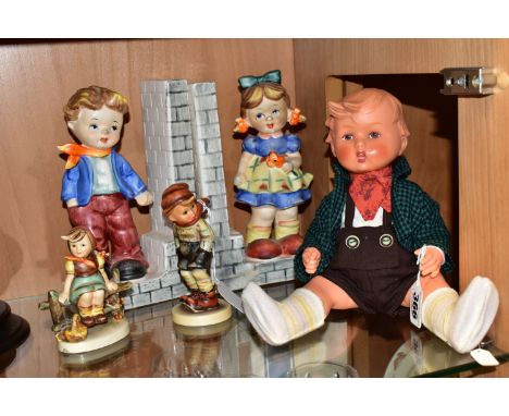 A PLASTIC GOEBEL HUMMEL BOY DOLL, TWO HUMMEL FIGURES AND A PAIR OF HUMMEL STYLE BOOKENDS, the doll with moulded hair, height 