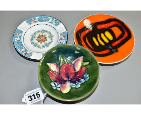 A MOORCROFT PIN DISH, A POOLE PIN DISH AND A WEDGWOOD  'FLORENTINE' PATTERN ASHTRAY, the Moorcroft dish decorated with an orc