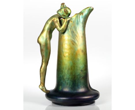 A HUNGARIAN EOSIN-GLAZED EWER 'WOMAN DRINKING FROM FOUNTAIN', ZSOLNAY PORCELAIN FACTORY, PECS, CIRCA 1900 designed by Sandor 