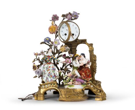 A DRESDEN PORCELAIN-MOUNTED ORMOLU CLOCK, EARLY 20TH CENTURY the clock supported by a pair of columns, the base modelled as a