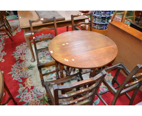 A small oak drop leaf table and four ladder back chairs (5) 