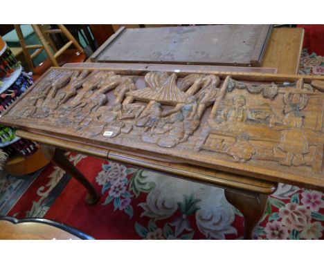 A large carved wood panel