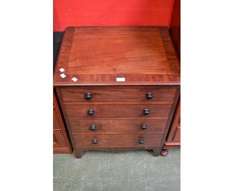 A George III mahogany commode in the form of a four drawer chest.