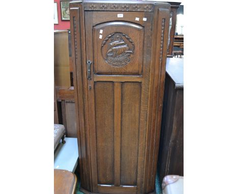 An oak hall robe, fielding panel to door carved with galleon in full sale 