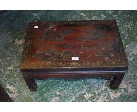 A Chinese lacquer low tea table, decorated in gilt  with monumental landscape, shaped apron, scroll feet, 30cm high, 59.5cm w