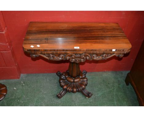 A William IV rosewood pedestal card table, rounded rectangular moulded top enclosing a baize-lined playing surface above a sh