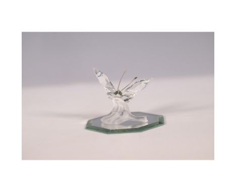 Elegant Swarovski crystal figurine featuring a delicate butterfly with intricately faceted clear crystal wings, perched on a 