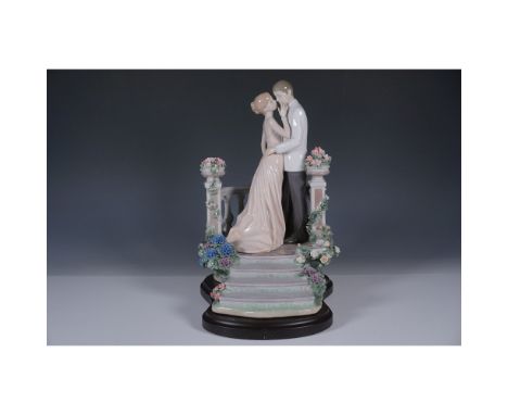 This is an exquisite Lladro porcelain figurine, a masterful depiction of romantic elegance and detailed artistry. The scene f