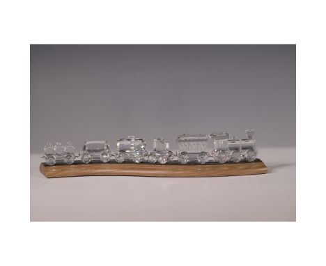 6pc Swarovski Silver Crystal train set featuring a locomotive and five railcars, displayed on a curved wooden track. Crafted 