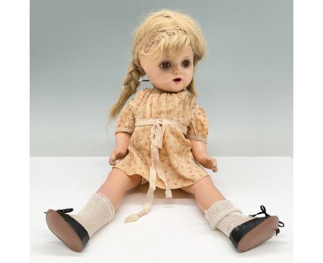 Vintage Alexander composition doll featuring a soft body with a composition head, arms, and legs. The doll has painted facial