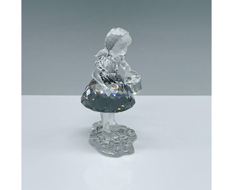 This enchanting Swarovski crystal figurine, "Red Riding Hood with Basket," was designed by Edith Mair and is a stunning repre