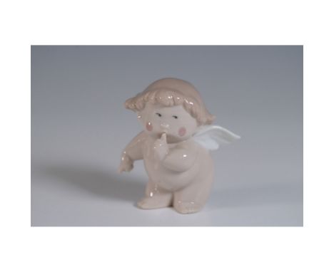 This delightful Nao porcelain figurine, titled "Cheeky Cherub," depicts a playful angel with a finger to its lips, as if aski