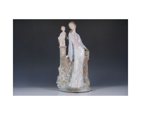 A beautiful porcelain figurine featuring a woman seated on a stone wall with intricate details, accompanied by a cherub holdi