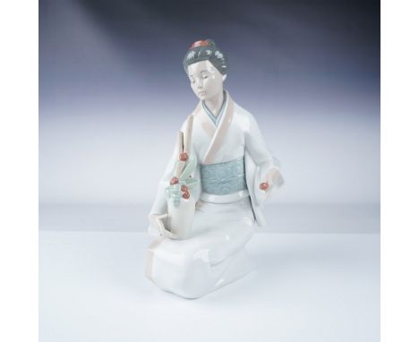 Elegant Nao by Lladro porcelain figurine featuring a kneeling geisha dressed in a flowing white kimono with a pale blue obi, 