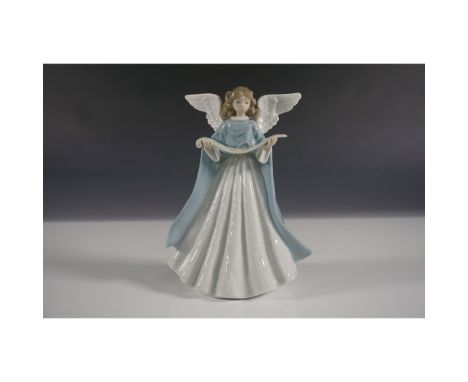 Elegant Lladro porcelain tree topper featuring an angel holding a scroll. This piece beautifully captures the holiday spirit 