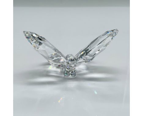 Exquisite Swarovski crystal figurine featuring a delicate butterfly perched on a faceted leaf. This elegant design showcases 