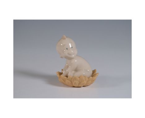 This Nao porcelain figurine, titled "From a Water Can?", features an adorable baby sitting in a watering can. Created by Nao 