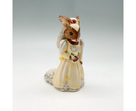 This fine bone china figurine from the Royal Doulton Bunnykins series depicts a charming bride holding a bouquet, dressed in 