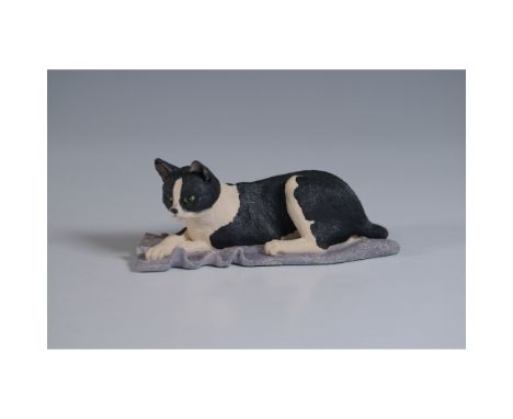 This Border Fine Arts figurine, titled Cat Lying (Black/White), features a beautifully detailed black-and-white cat resting o