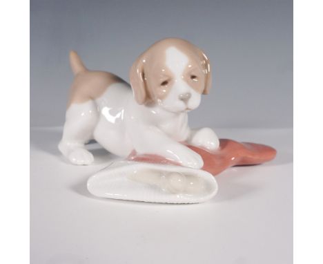 Nao by Lladro Puppy with Stocking figurine, model number 1427, a charming porcelain sculpture capturing the playful innocence