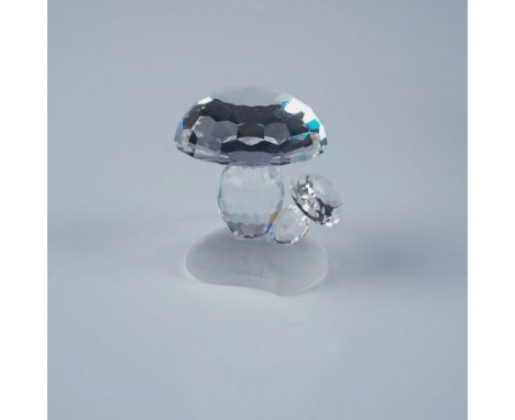 Swarovski crystal figurine featuring a charming pair of mushrooms crafted in faceted clear crystal. The mushrooms rest on a m