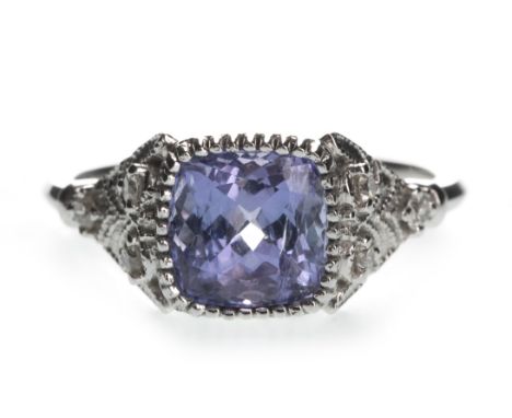 TANZANITE AND DIAMOND RING, set with a cushion shaped tanzanite of approximately 1.50 carats, with three round brilliant cut 