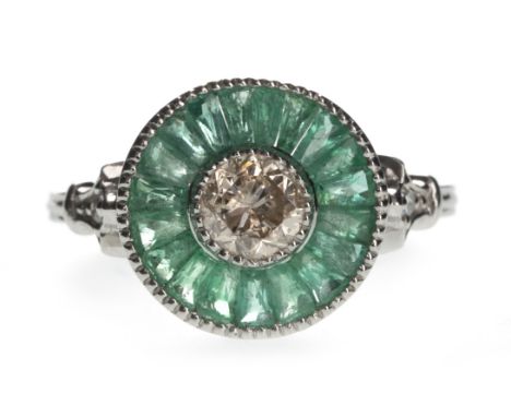 EMERALD AND DIAMOND TARGET RING, set with a central round brilliant cut diamond of approximately 0.50 carats, within a border