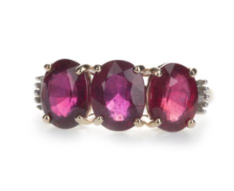 RUBY AND DIAMOND RING, set with three oval rubies flanked by baguette cut diamonds totalling approximately 0.25 carats, marke