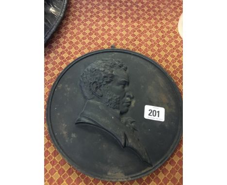A Russian cast iron circular relief plaque decorated with a side portrait of Pushkin, signed and inscribed to reverse.
