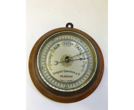 An early 20th century Simpson Lawrence & Co., Glasgow small circular wall barometer in oak frame.