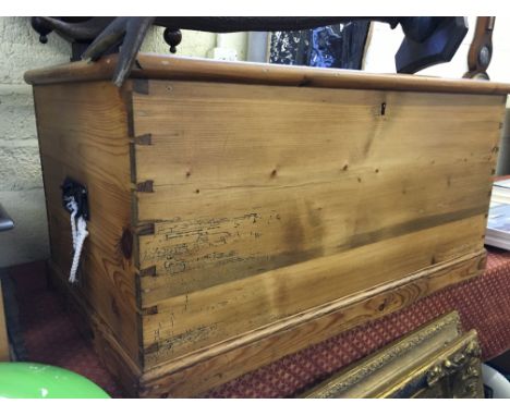 A pine lift-top trunk with interior compartment.