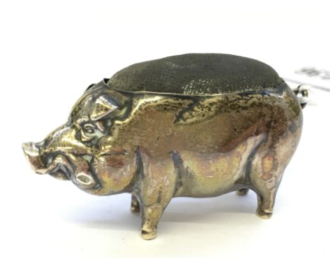 An Edwardian silver pig shaped pin cushion with original velvet body.