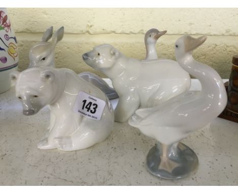 A white glazed Lladro china figure modelled as a Polar Bear together with another and three similar items.