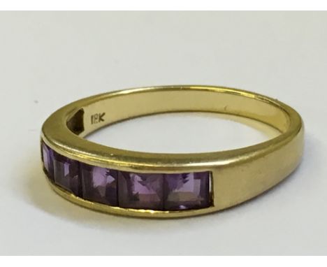 An 18K amethyst five stone dress ring.