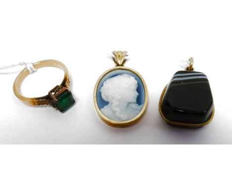 9ct yellow gold pendant set with blue and white cameo bust, an onyx pendant set in gold mount and a gold-coloured metal ring 