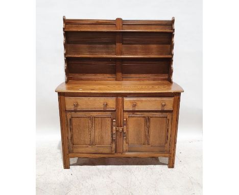 Mid-coloured Ercol dresser, the waterfall top with two plateracks, on a base of two drawers and two cupboard doors, 150cm x 1