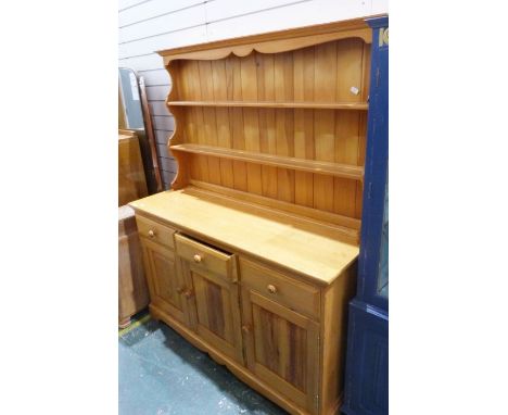 Modern pine dresser, the ogee moulded cornice above plate shelves, on base of three drawers and three cupboard doors, to brac