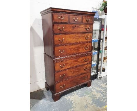 Georgian chest on chest, the moulded cornice above three short over three long drawers, the base with brushing slide and thre