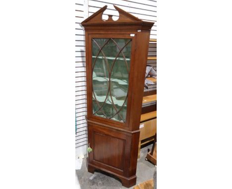 Modern mahogany corner display cabinet, the architectural pediment above astragal-glazed door, above single cupboard door, on